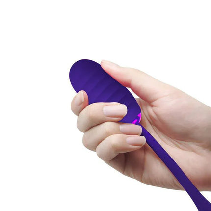 Hand holding Kirk Vibrating Egg Violet showcasing the textured silicone surface designed for versatile pleasure with 12 vibration settings.