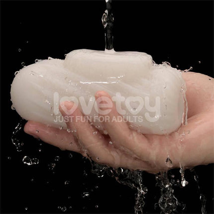 Knights Ring Vibrating Dual Purpose Sleeve for versatile pleasure and girth boost, shown held under running water.