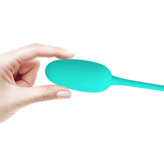 Hand holding Knucker Vibrating Egg Green, a body-safe silicone device with 12 functions for versatile pleasure and USB rechargeable design.