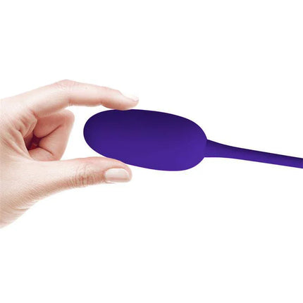 Knucker Vibrating Egg Purple compact silicone vibrator shown in hand for size reference.