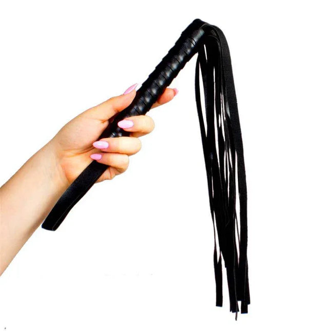 Hand holding Leather Flogger 45 cm Black with thin leather-style straps for controlled strokes.