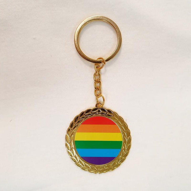LGBT Pride Round Metal Keychain with rainbow colors, symbolizing inclusion and support, against a white background.