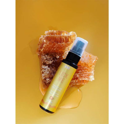 Lick Me Honey Kissable Gel with Warm Effect 50 ml bottle on honeycomb background
