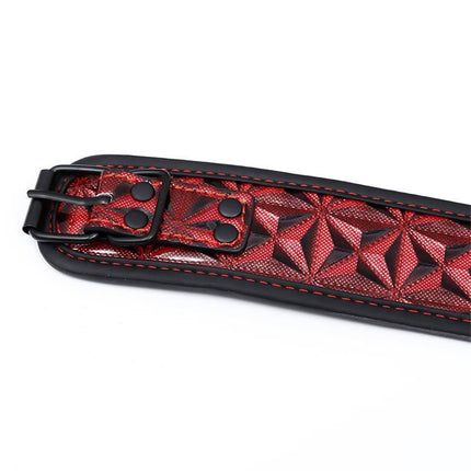 Close-up of llar with Nipple Clamps Diamond Vegan Leather showing red geometric pattern and black buckle.