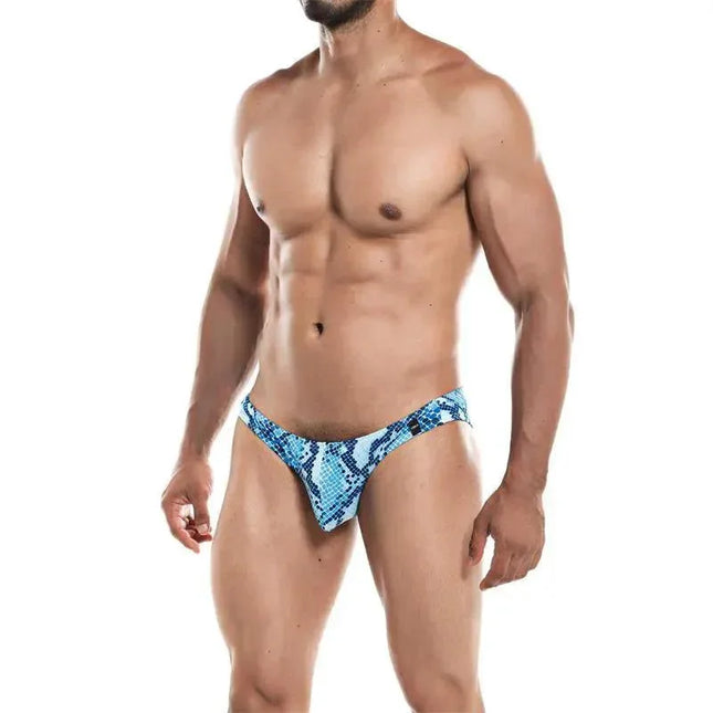 Model wearing Low Rise Bikini Brief Provocative Snake by Cut4men, showing a sleek and modern men's silhouette in blue snake print.
