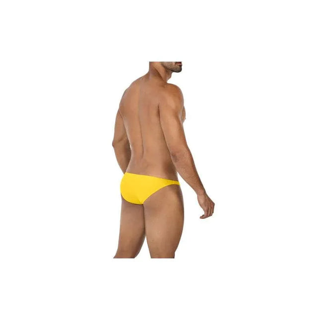 Model wearing Low Rise Bulge Brief C4MSPXBUL01 Yellow Size S by CUT4MEN, showcasing a sleek silhouette and comfortable fit for daily wear.