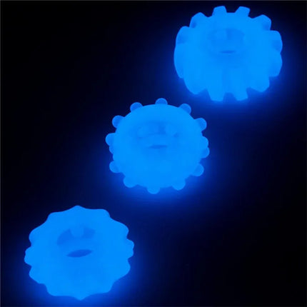 Lumino Play Set 3 Penis Ring Blue Light glowing in darkness, showcasing three soft TPE cock rings for comfort and versatile wear.