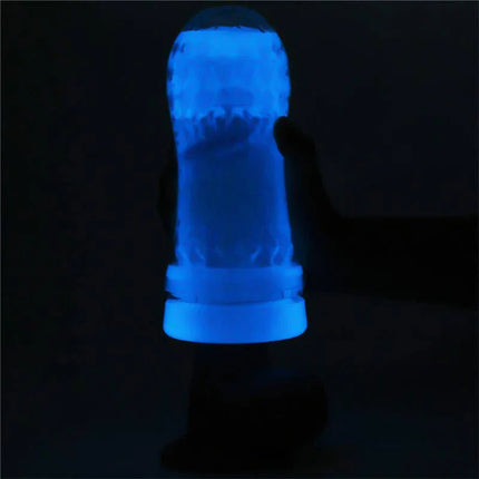 Lumino Blue Light Male Masturbator glowing in the dark, showcasing its blue light feature for enhanced pleasure in low light environments.