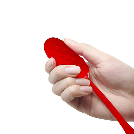 Hand holding Marina Vibrating Egg Red with textured silicone surface for sensual solo play