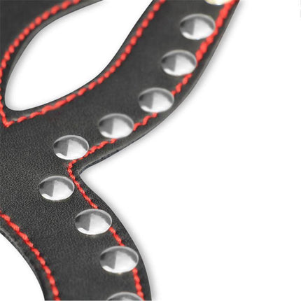 Close-up of Mask Adjustable faux leather with red stitching and metal studs.