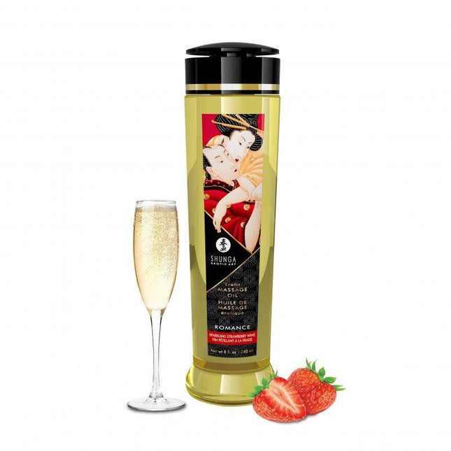 Massage Oil Romance 240 ml bottle with glass of champagne and strawberries.