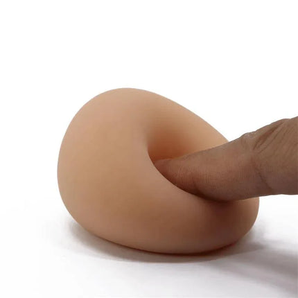 Masturbator Egg II Orange for Ultimate Pleasure demonstrating its flexible design with a finger pressing into the egg-shaped surface.