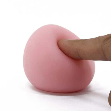 Masturbator Egg Pleasure Egg I Pink demonstrating flexible exterior with a finger showing texture and softness.