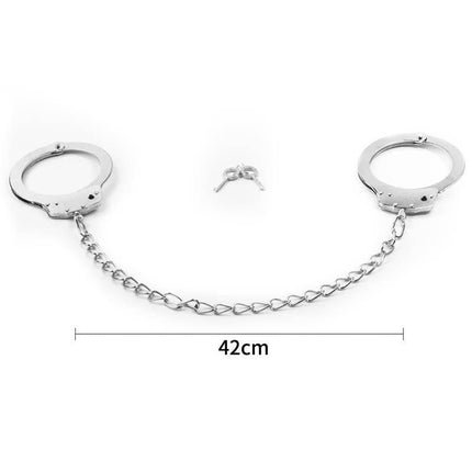 Metal Ankle Cuffs with chain and keys, featuring a quick release lever for safety, ideal for couples' bondage play in silver metal.