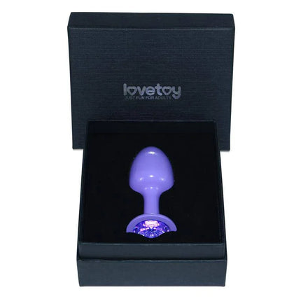 Metal Butt Plug Purple Rosebud with Blue Jewel in black box, highlighting its nickel-free metal for safe and comfortable use.