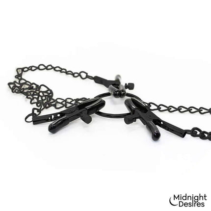 Nipple and Clitoral Clamps by Midnight Desires, featuring stylish vegan leather and adjustable design for adventurous pleasure.