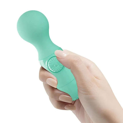 Hand holding Mini Massager Little Cute Green, compact waterproof silicone wand for targeted stimulation and travel convenience.