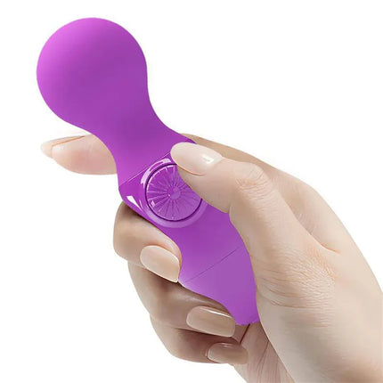Hand holding Mini Massager Little Cute Purple, compact purple wand for portable relaxation and focused relief, 12 cm size