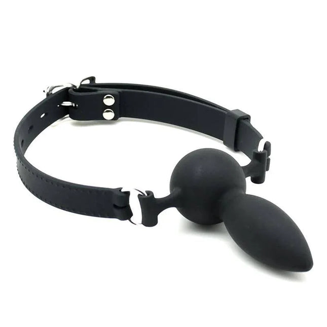 Mouthgag with Plug Silicone - black silicone mouth gag with metal buckle and adjustable strap for secure restraint.