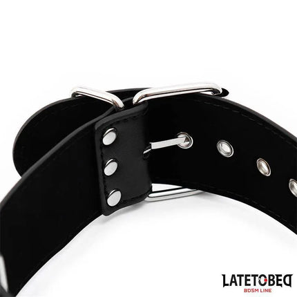 Close-up of black neck and wrist cuff from Latetobed BDSM line showing adjustable collar with metal buckles.