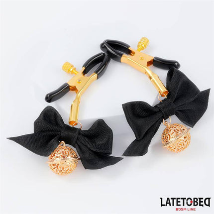 Nipple clamps with Bow Black featuring gold bells, designed for customizable pleasure in BDSM play. Latetobed BDSM Line product.