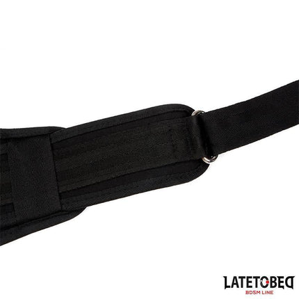 Close-up of Pad Door Jam Sling, a black over-door swing for adjustable BDSM play, showcasing the durable strap and metal loop detail.