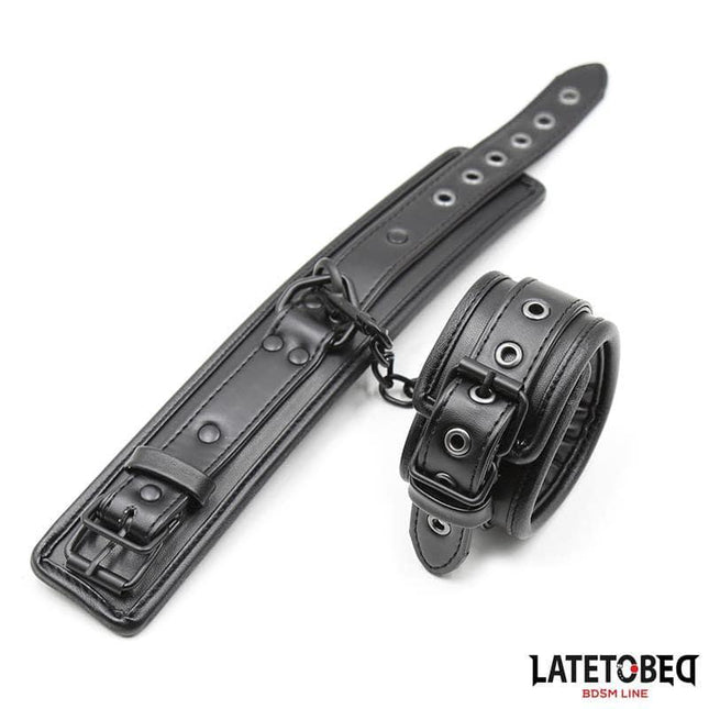 Padded Handcuffs Adjustable in black leather with padded interior for comfort and adjustable length, perfect for intimate play.