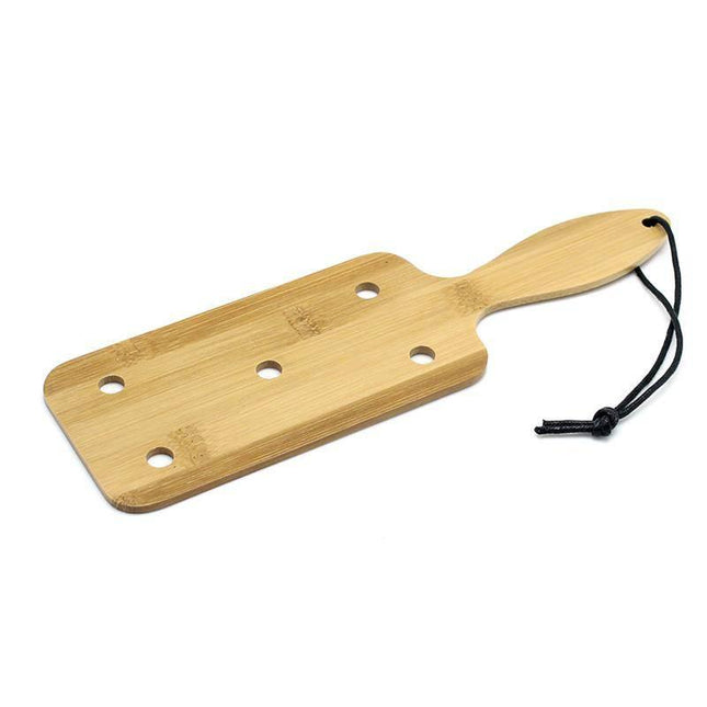 Paddle Bamboo, a lightweight BDSM accessory made from bamboo, featuring an ergonomic design with holes for enhanced sensation and ease of use.
