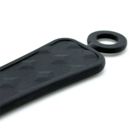 Close-up of the black Paddle Silicone 37 cm showing textured surface and ring handle for BDSM use.