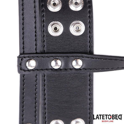 Close-up of adjustable black Penis Cage with metal detailing, crafted from PVC and metal for comfort and control.