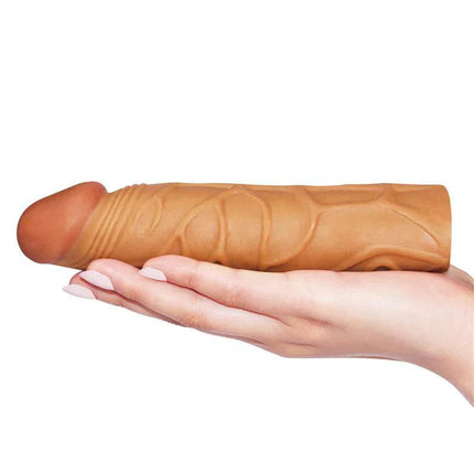 Hand holding Penis Sleeve Pleasure X Tender Brown with realistic glans and veined shaft for intensified stimulation.