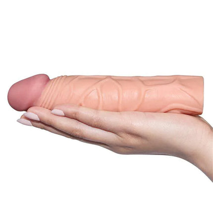 Realistic design of Penis Sleeve Pleasure X Tender Flesh held in hand for enhanced stimulation.