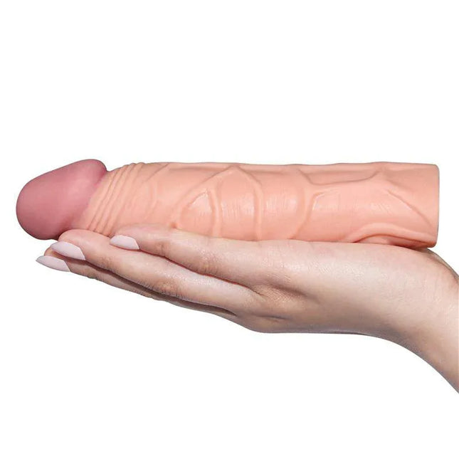 Realistic design of Penis Sleeve Pleasure X Tender Flesh held in hand for enhanced stimulation.