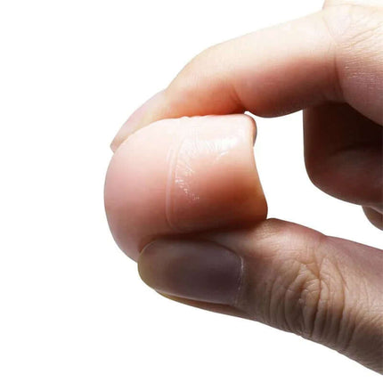 Close-up of flexible texture on Penis Sleeve with Extension held between fingers