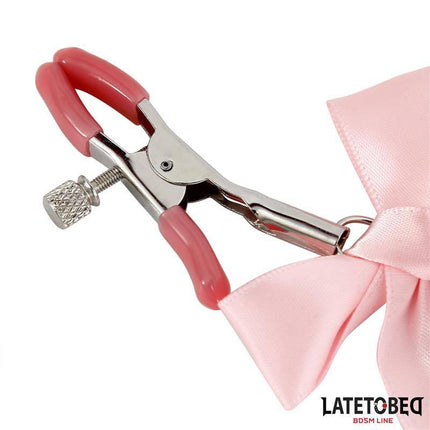 Pink Bow Nipple Clamps with Bell in a close-up view showcasing pink pads, silver metal clamp, and decorative bow.