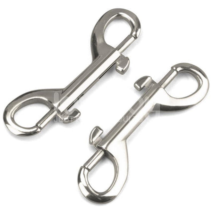 Close-up of two silver metal snap hooks for secure fastening in bondage gear applications.