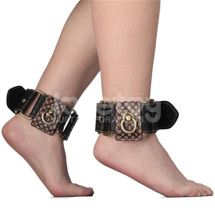 Rebellion Reign Ankle Cuffs with vintage bronze spikes in premium PU material displayed on ankles, luxury-meets-rustic bondage gear.