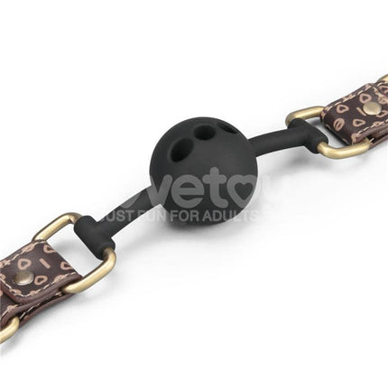 Rebellion Reign Breathable Silicone Ball Gag with antique bronze spikes on dark brown faux leather straps.