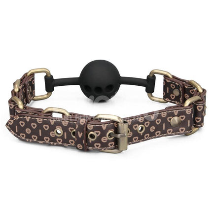 Rebellion Reign Breathable Silicone Ball Gag with antique bronze spikes on dark brown faux leather, featuring a breathable silicone ball.