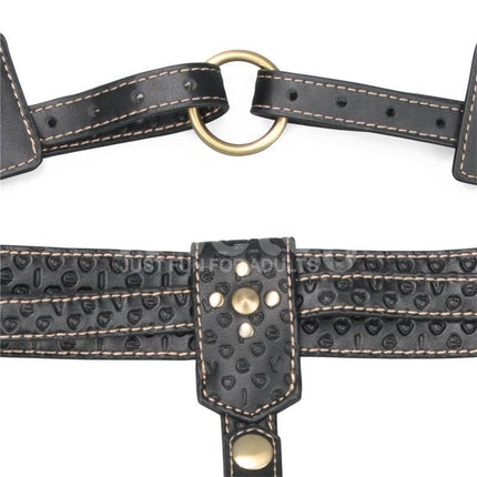 Close-up of Rebellion Reign Full Body Harness showcasing gold hardware and textured black PU faux leather straps.