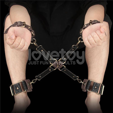 Person using Rebellion Reign Hogtie Set with handcuffs and ankle cuffs featuring bronze spikes.