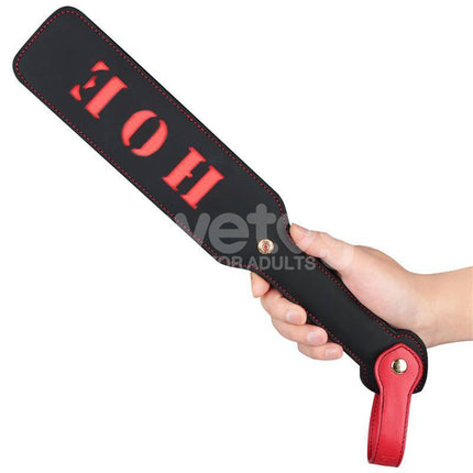Hand holding Rebellion Reign Paddle HOE 15 with HOE cut-out design and durable black and red finish.