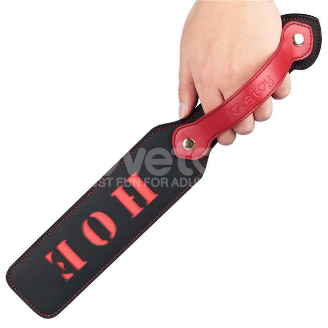 Hand holding Rebellion Reign Paddle HOE 15 with cut-out design