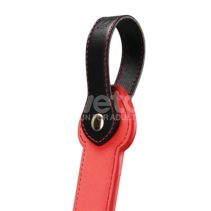 Close-up of the Rebellion Reign Rope Paddle 15 with black loop and red stitching detail for bold sensations.