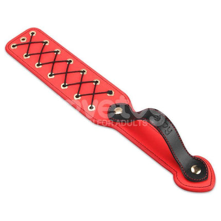 Rebellion Reign Rope Paddle 15 with red and black crisscross design, offering bold aesthetics and textured sensations for adventurous play.
