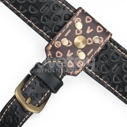 Close-up of Rebellion Reign Strap-On Harness showing durable PU material and intricate heart pattern design.