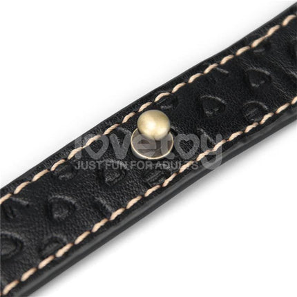 Close-up of black leather strap with stitching and stud detail for Rebellion Reign Tie Collar.