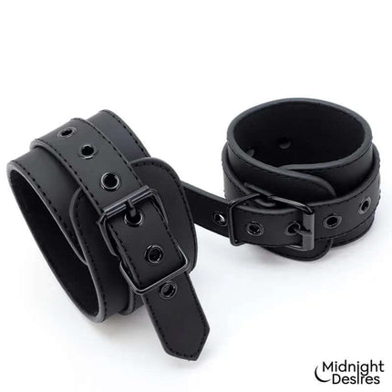 Rigid Crossed Bar with Cuffs in black vegan leather by Midnight Desires, featuring adjustable and detachable cuffs for secure restraint.