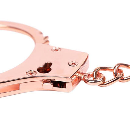 Close-up of Rose Gold Color Cuffs Skull Keys with a chic rose-gold finish and distinctive skull-key design for mature couples.