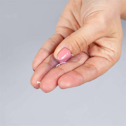 Hand holding Secret Play Hot Effect Blackberry Lubricant 50 ml showcasing texture and application.